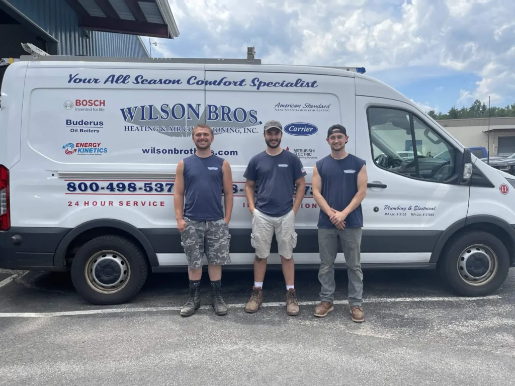 Wilson Bros. service technicians beside a company vehicle